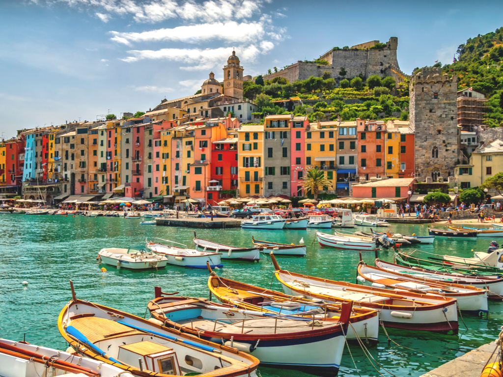 harbor of porto venere italy with boats in the foreground, one of the best small villages in italy