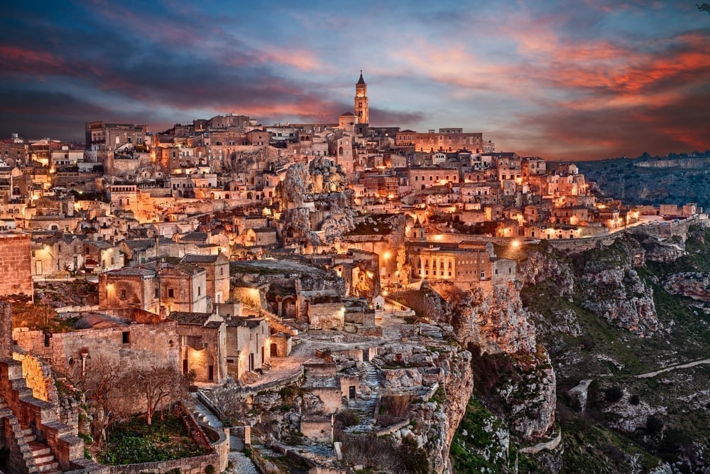 Matera at sunset with the lights in the city turned on, one of the prettiest small towns in Italy