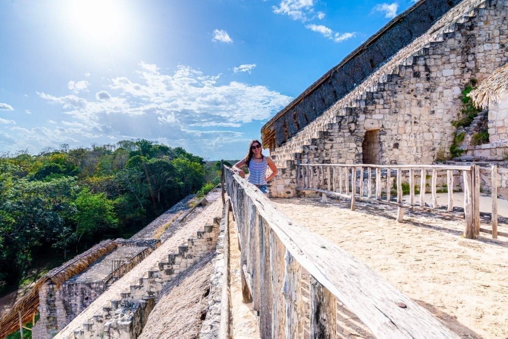 Kate Storm standing on a platform halfway up el torre when visiting ek balam ruins