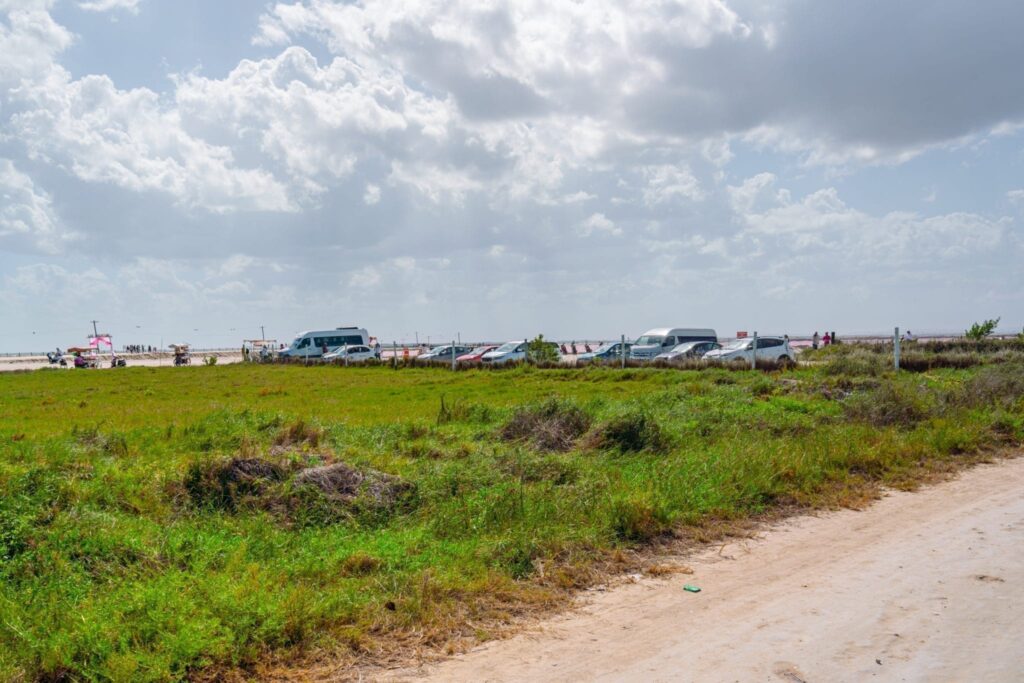 Parking lot of Las Coloradas pink lakes visible in the background