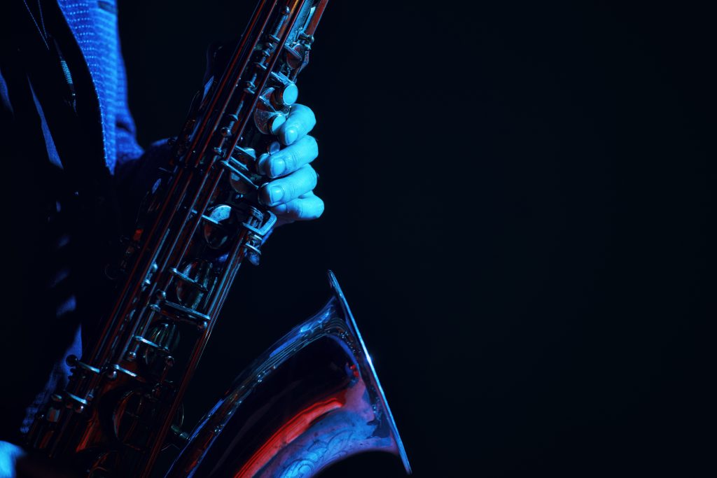 saxophone being played in a dark jazz club