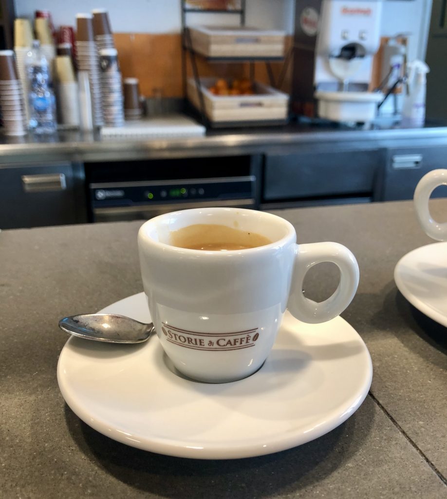 shot of coffee in a white cup in an autogrill in italy