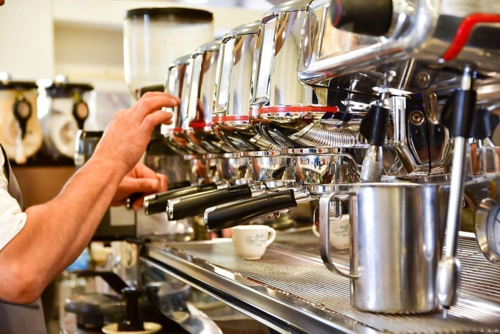 Large espresso machine demonstrating coffee in Italy