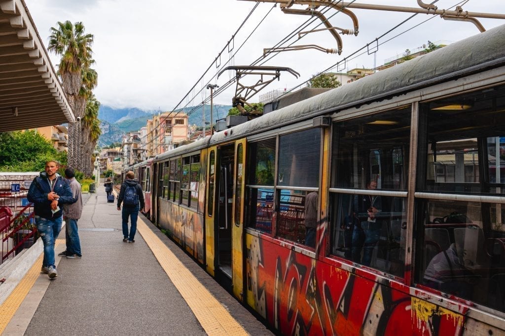 circumvesuviana train stopped at the station and waiting for people to board