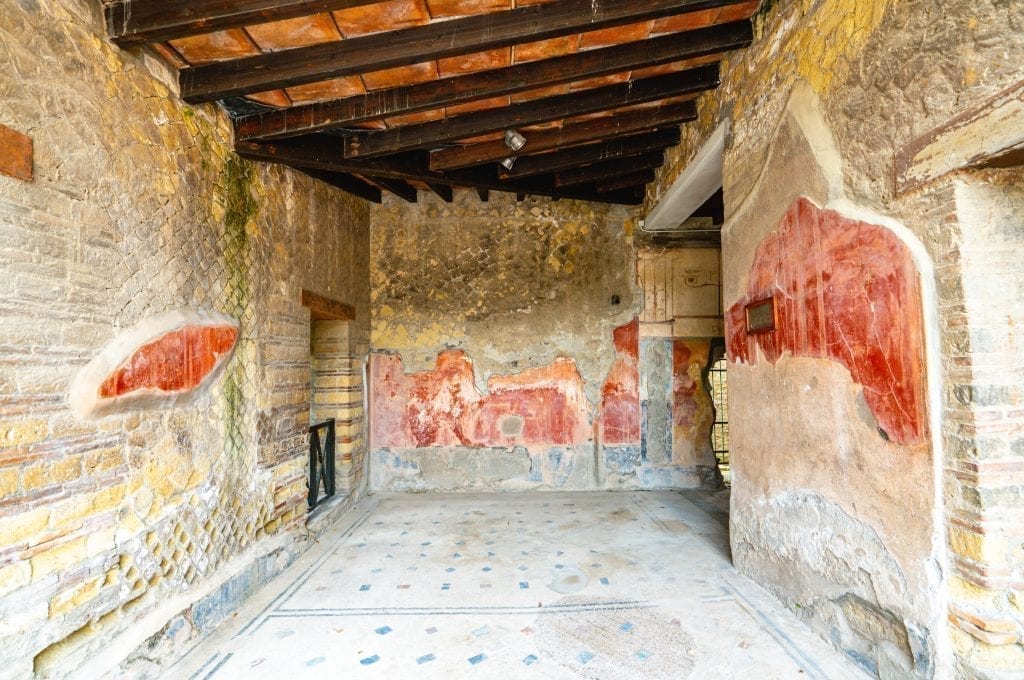 ancient frescoes inside a building as seen when visiting herculaneum
