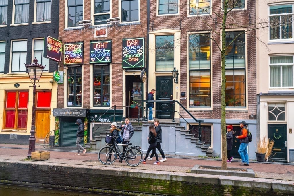 people walking through red light district in amsterdam netherlands