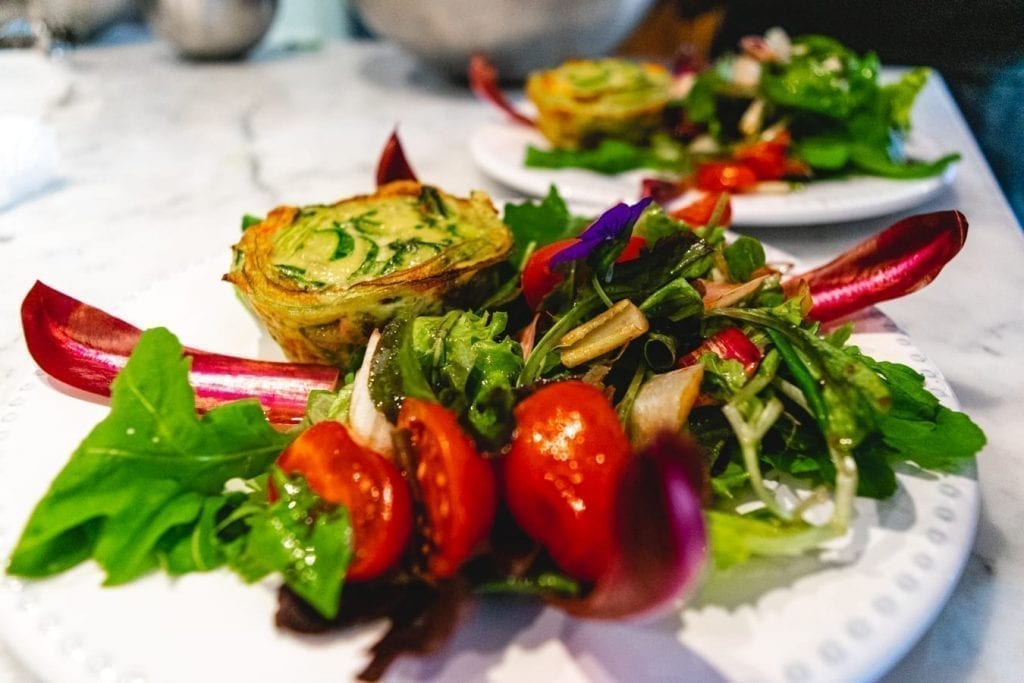 plate of greens and a tart served at a cooking class in lucca italy