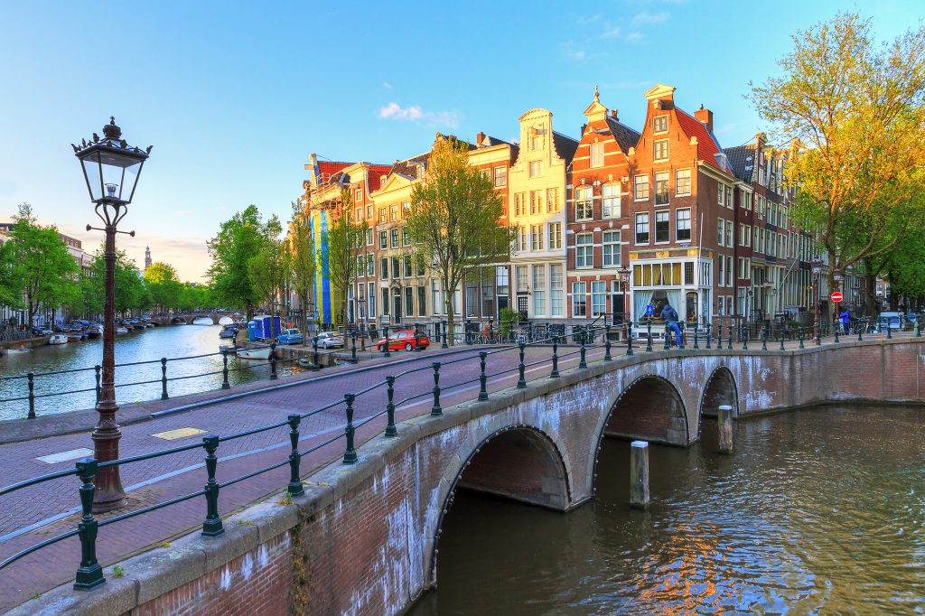 bridge leading over a canal amsterdam netherlands
