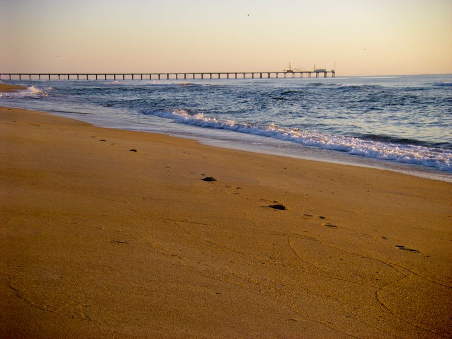 Beach of Duck North Carolina at sunset with one set of footprints in the sand. The Outer Banks of NC are some of the most beautiful beaches in the US