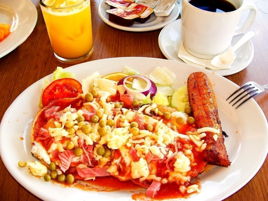 Huevos motulenos on a white plate, a typical Mexican breakfast in the yucatan