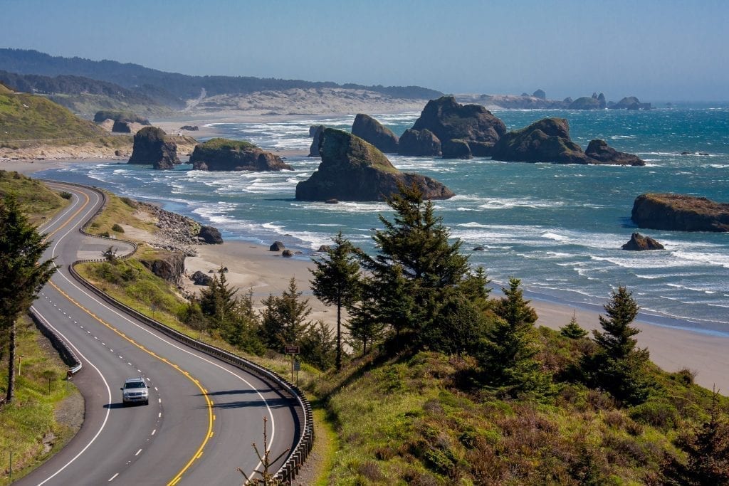 One car driving along the oregon coast as shot from above