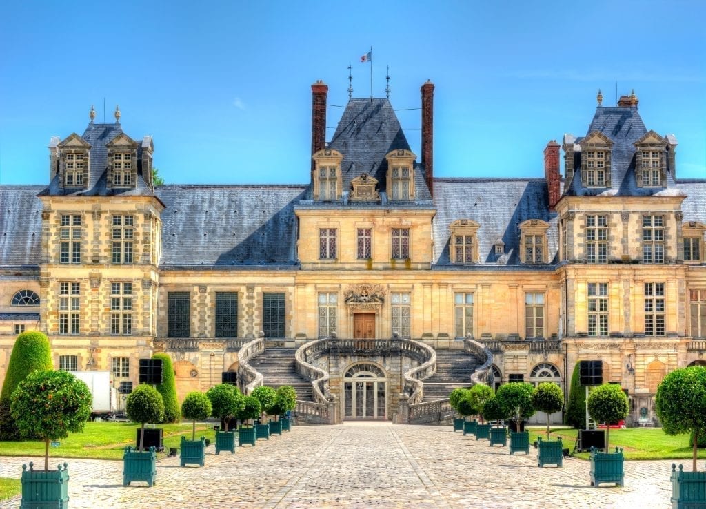 Exterior of Château de Fontainebleau as seen from the front, one of the best day trips from Paris France