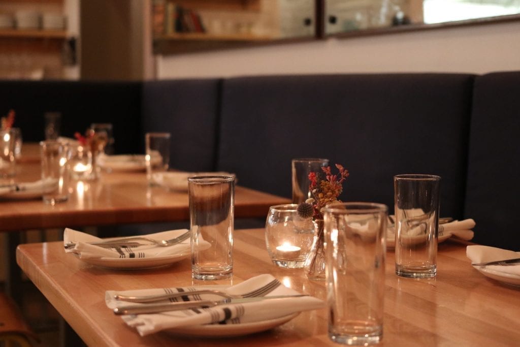 Place settings at a nice restaurant with black booths
