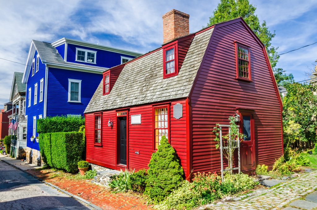bright red and blue buildings in newport, one of the most beautiful small american towns