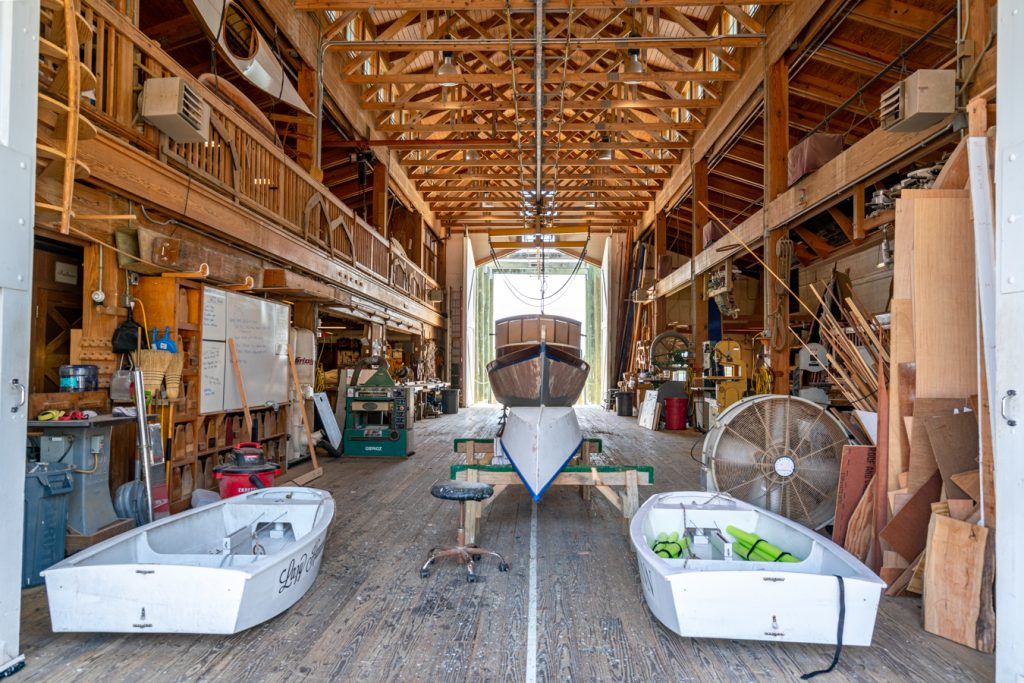 interior of the harvey w smith watercraft center with boat being built in the center, one of the top beaufort attractions