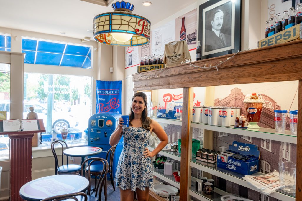 kate storm holding up a pepsi in the birthplace of pepsi cola, one of the best activities new bern nc