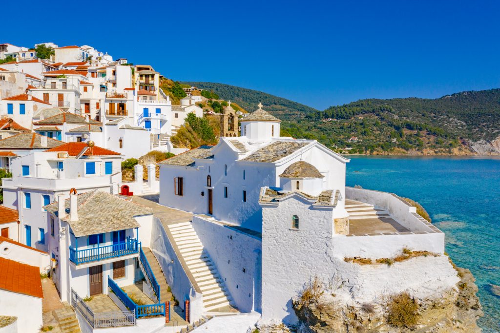 view of a village on skopelos greece with the sea visible to the right