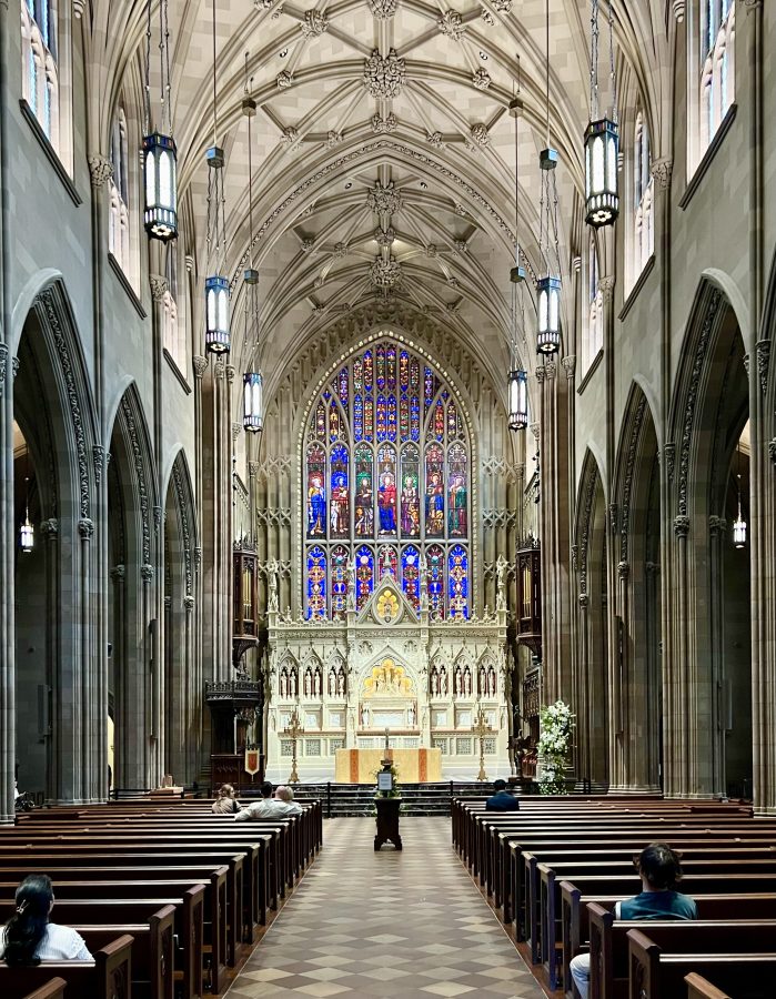 interior of trinity church, one of the best places to visit in nyc financial district, with colorful stained glass at the front