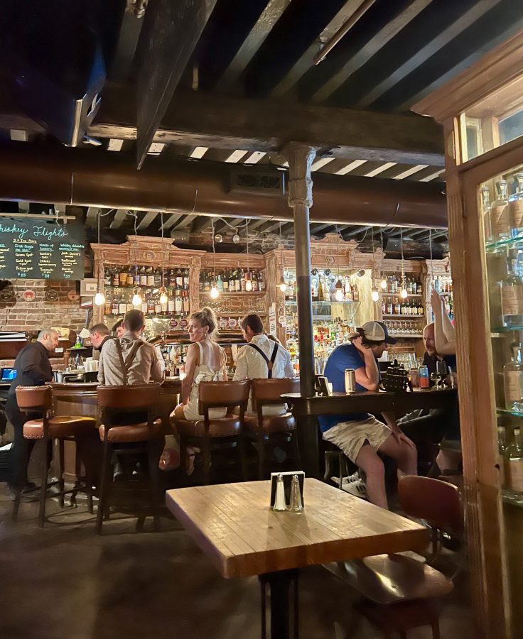 group of people sitting at the dingle whiskey bar in fraunces tavern in new york city financial district