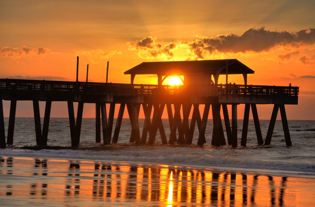 bright orange sunset at tybee pier at savannah beach at night