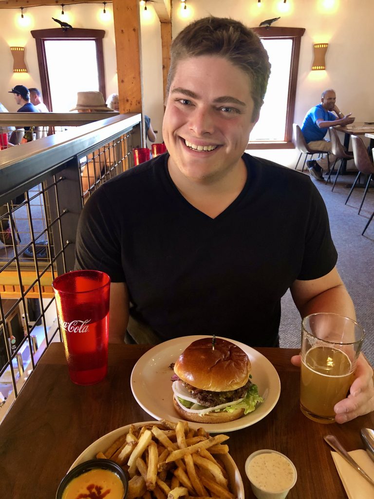 jeremy storm with a burger at trailhead food moab utah