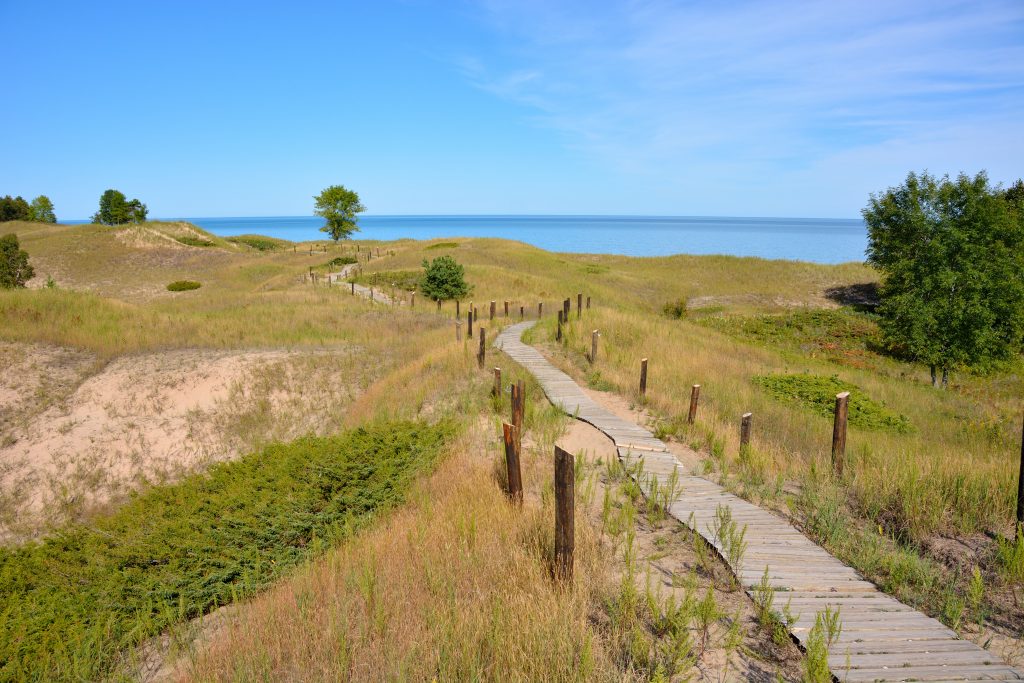 hiking trail leading to lake michigan in sheboygan, one of the most underrated vacation spots in the us