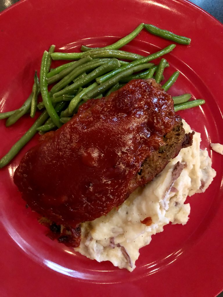 meatloaf on a red plate from amos mosquitos restaurant atlantic beach north carolina