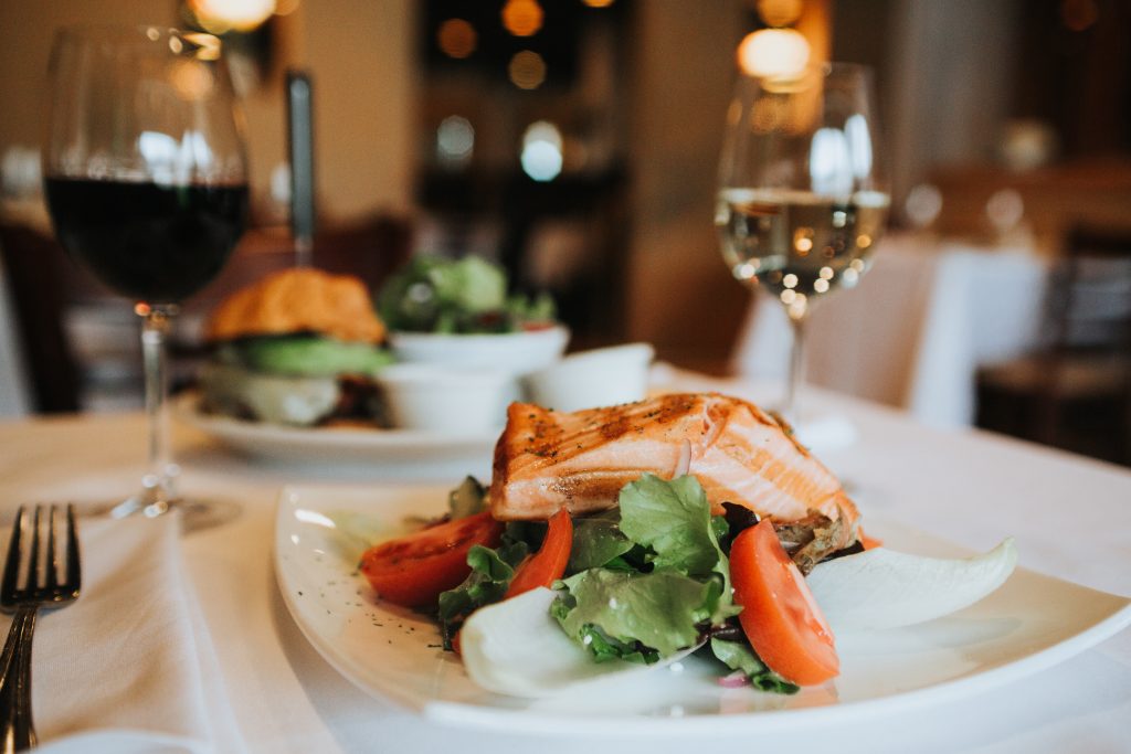 upscale plate of seafood featuring grilled fish on a white plate