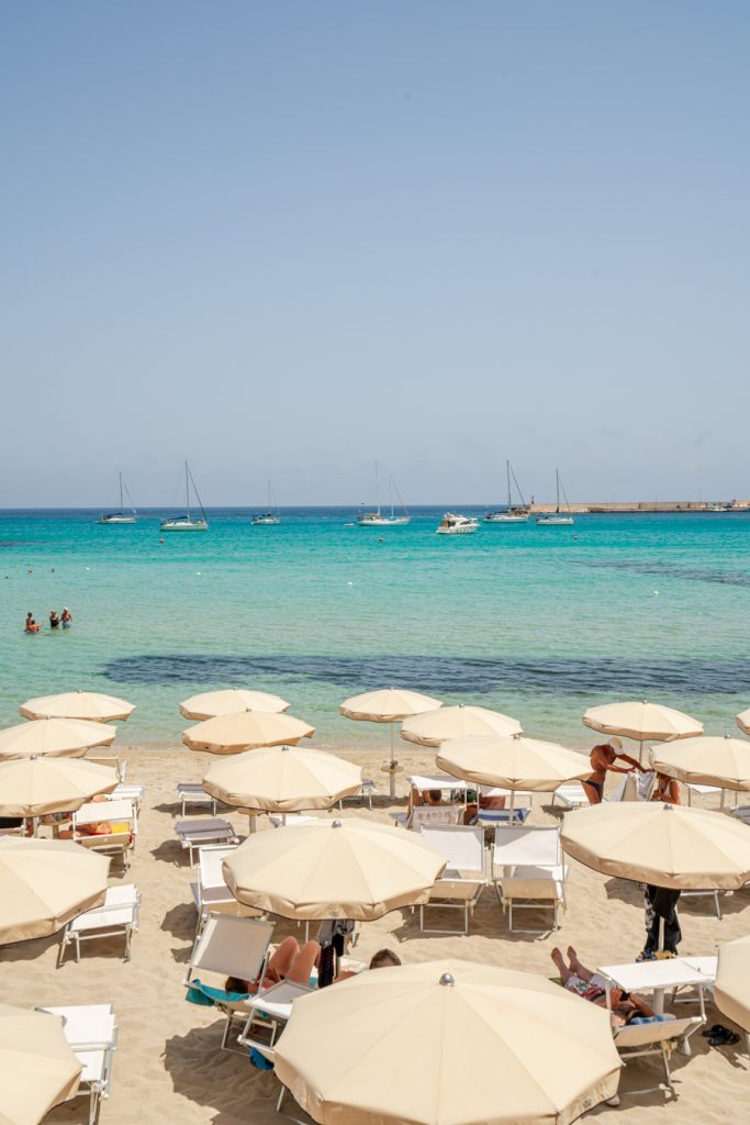 umbrellas of a lido overlooking the sea as seen when visiting otranto italy