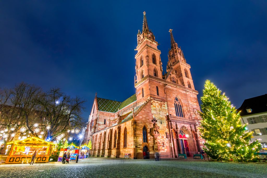 basel switzerland christmas market next to the munster cathedral, one of the best winter destinations in europe winter getaways