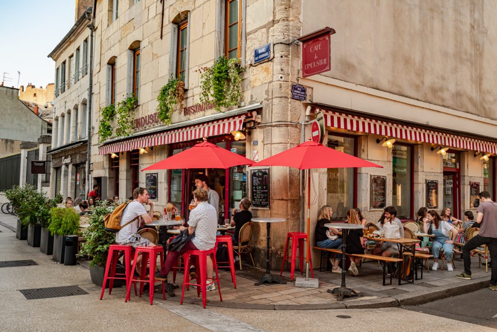 people eating dinner on a terrace at a restaurant dijon france
