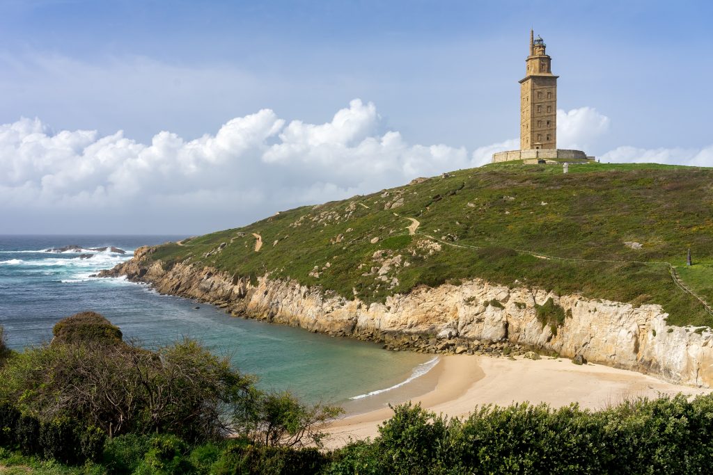 tower of hercules with beach in the foreground in galicia