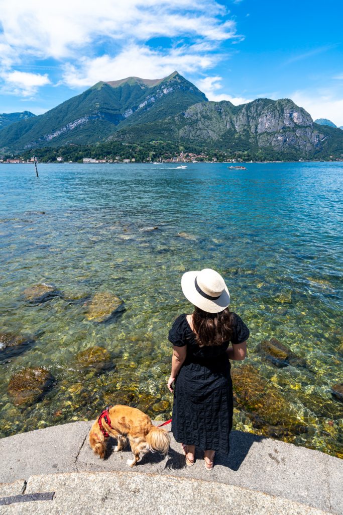kate storm and ranger storm standing on the edge of the water in bellagio, a popular stop on a day trip to lake como from milan italy