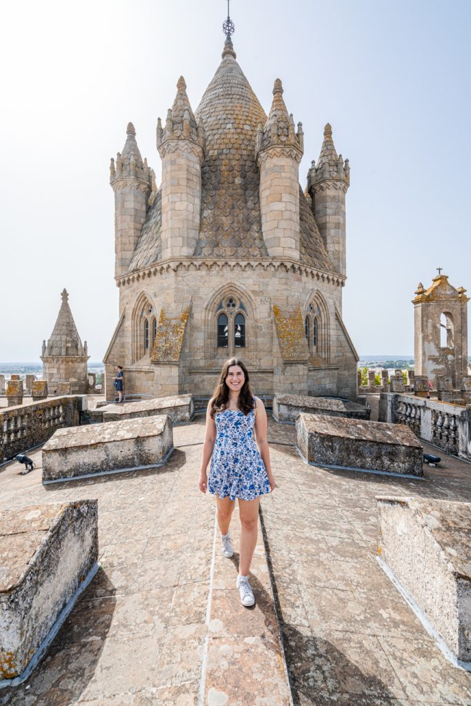 kate storm standing on the rooftop of the evora cathedral, one of the best things to do in evora portugal