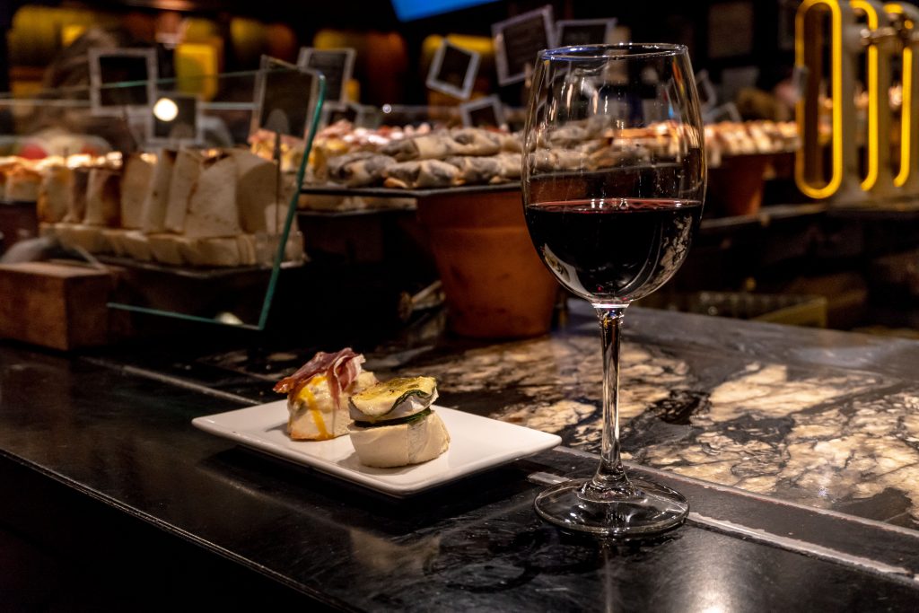 glass of wine with tapas in madrid market