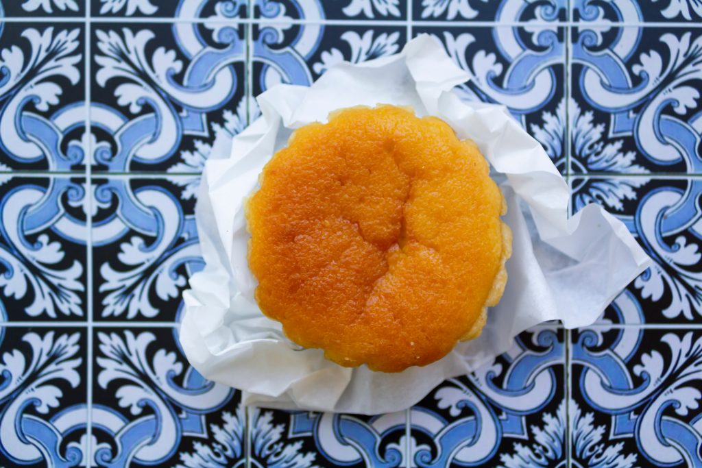 portuguese cheesecake pastry with azulejos in the background