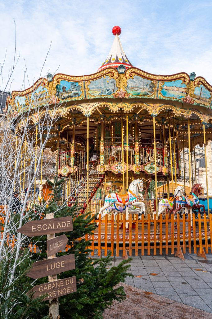 carousel in front of hotel de ville at paris christmas market