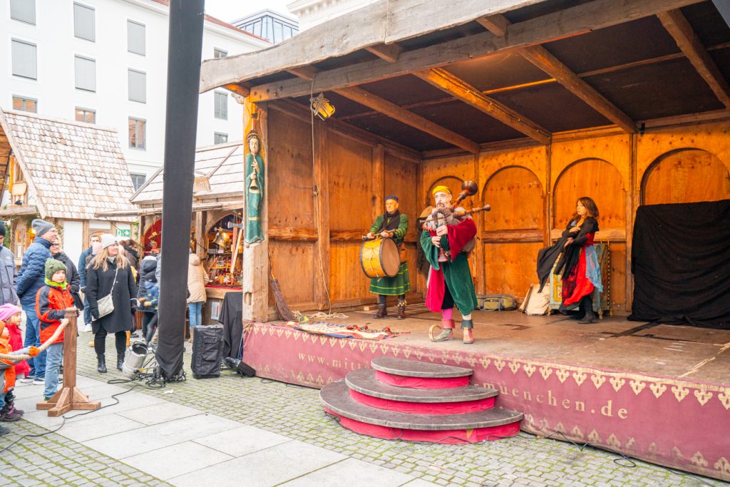 performers on stage at the munich medieval market as seen when visiting bavaria at christmas