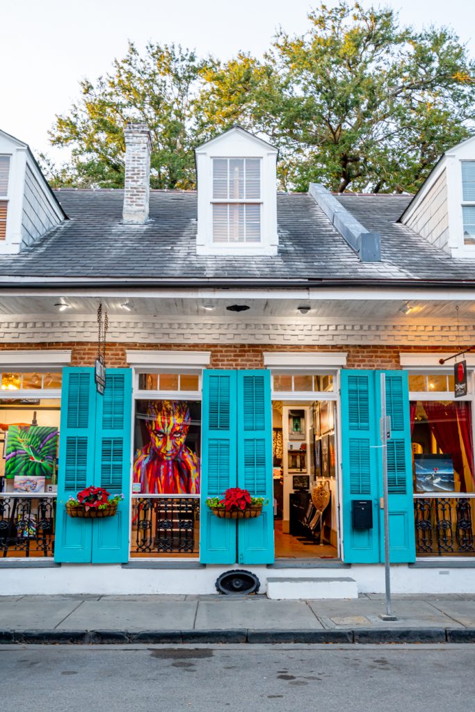 vibrant building in the new orleans french quarter with turquoise shutters, as seen during a day in nola