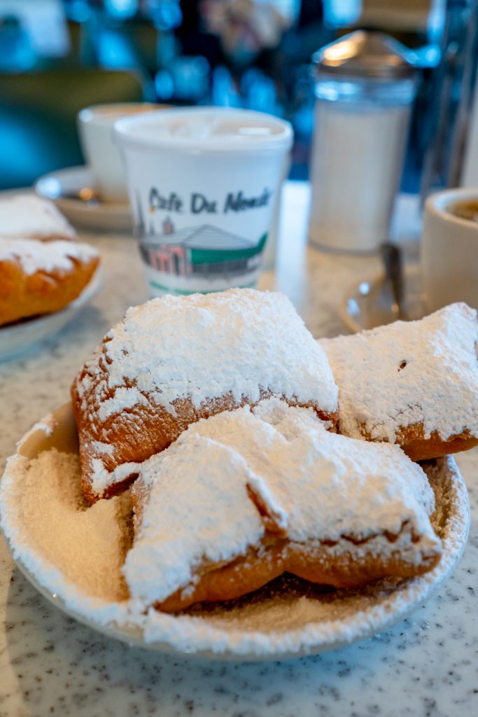 close up of beignets and chicory coffee at cafe du monde new orleans