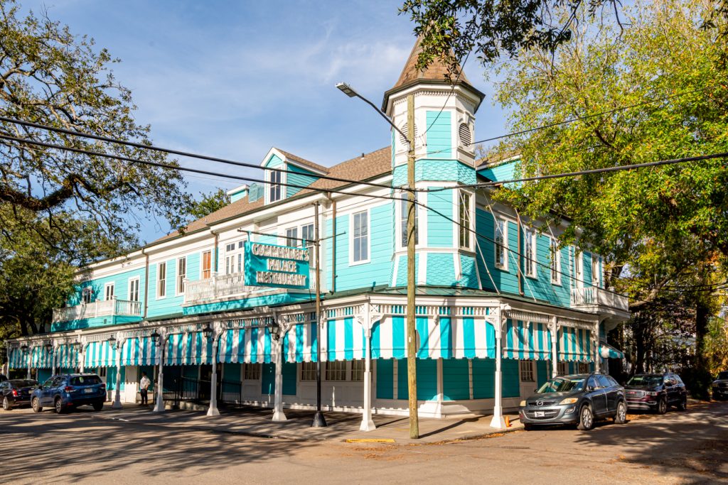 front facade of teal commanders palace in the garden district nola