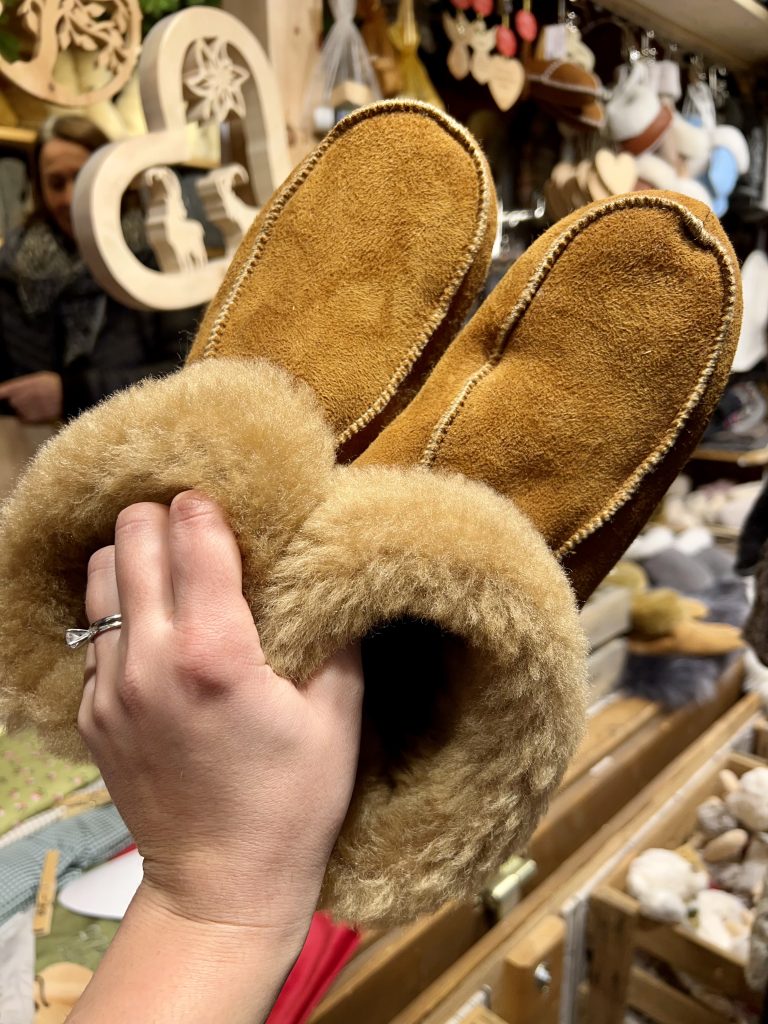 kate storm holding up wool slippers purchased in munich during the christmas season in bavaria germany