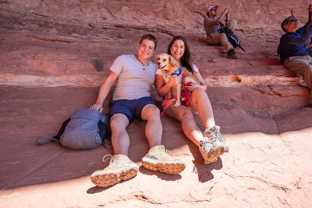kate storm jeremy storm and ranger storm resting in a cave while hiking in sedona as part of a road trip itinerary southwest usa