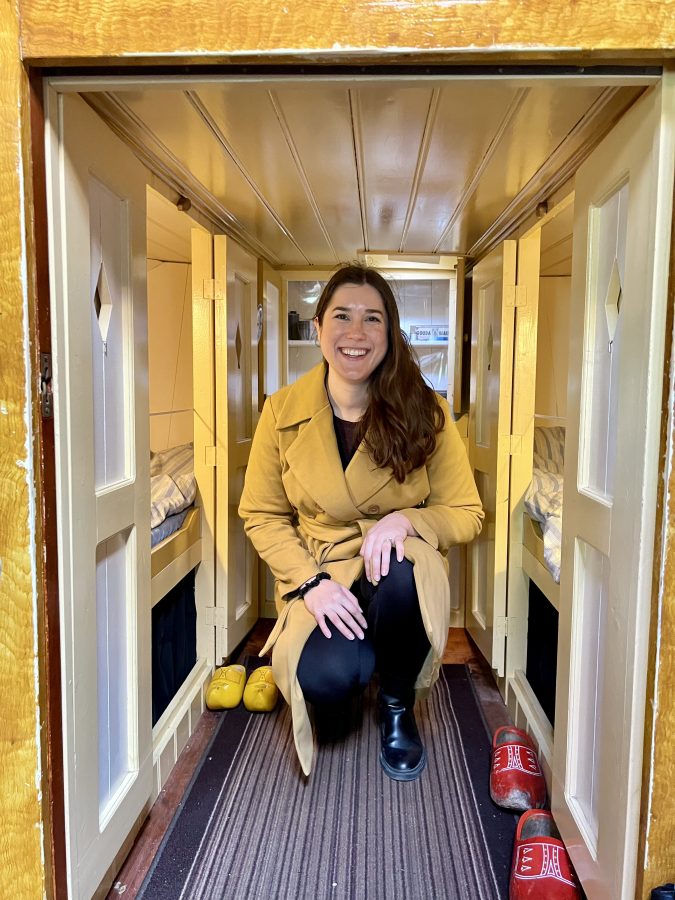 kate storm kneeling down in a small part of the amsterdam houseboat museum when visiting amsterdam april