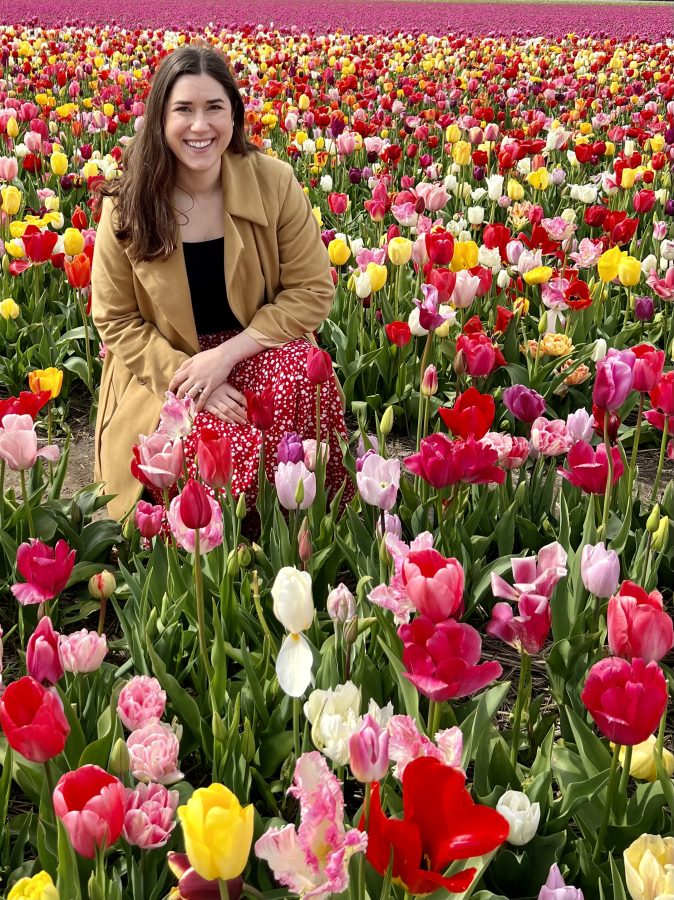 kate storm kneeling amongst tulips in the netherlands in april