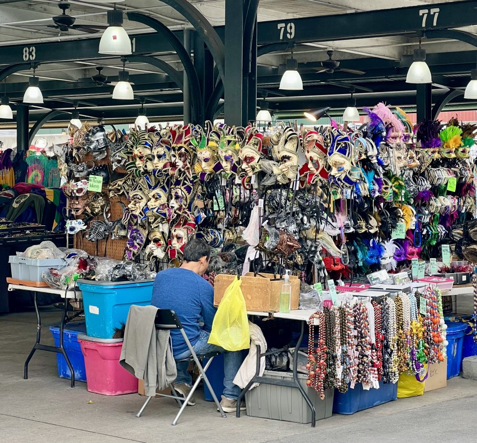 stand in french market nola selling mardi gras masks and beads