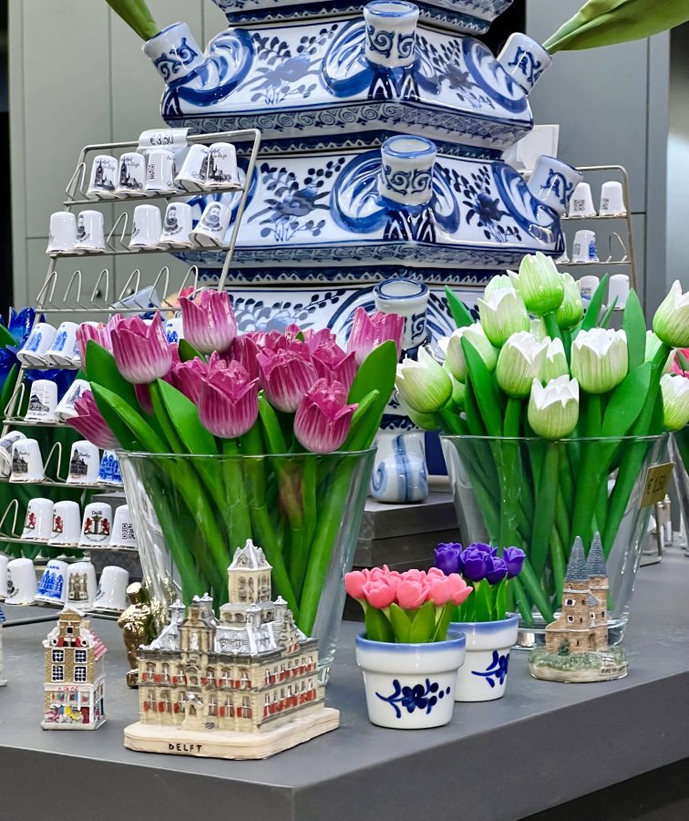 collection of blue and white ceramic souvenirs from the netherlands for sale in delft, along with figures of tulips