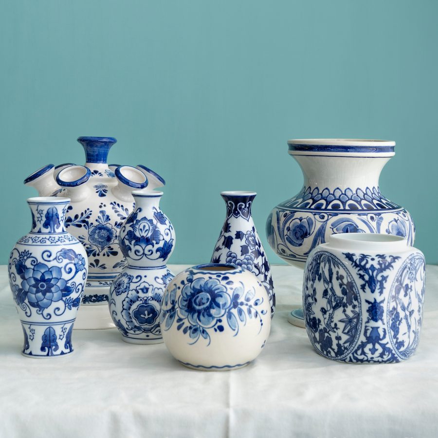 display of several pieces of traditional blue and white delftware, including a traditional tulip vase