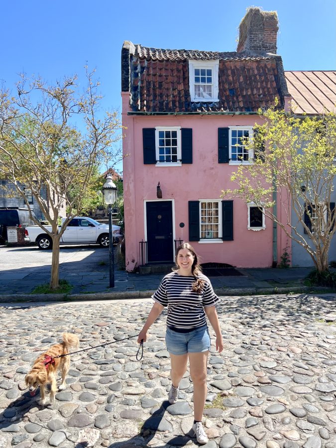 kate storm and ranger storm in front of the pink house at 17 chalmers street, one of the best photo spots in charleston