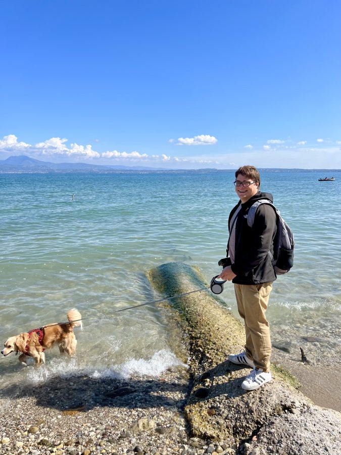 jeremy storm and ranger storm on the edge of the water at a beach in sirmione lake garda